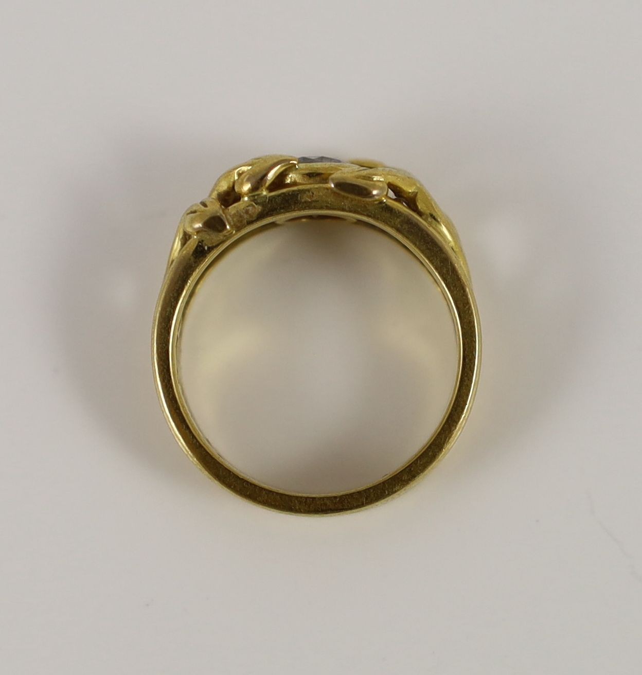 A modern pierced 18ct gold and solitaire diamond set band